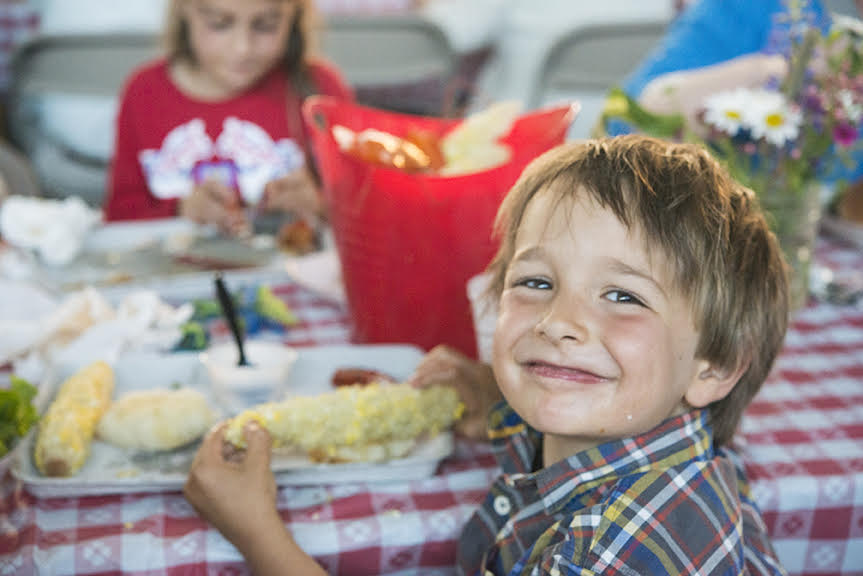 Kid eating corn